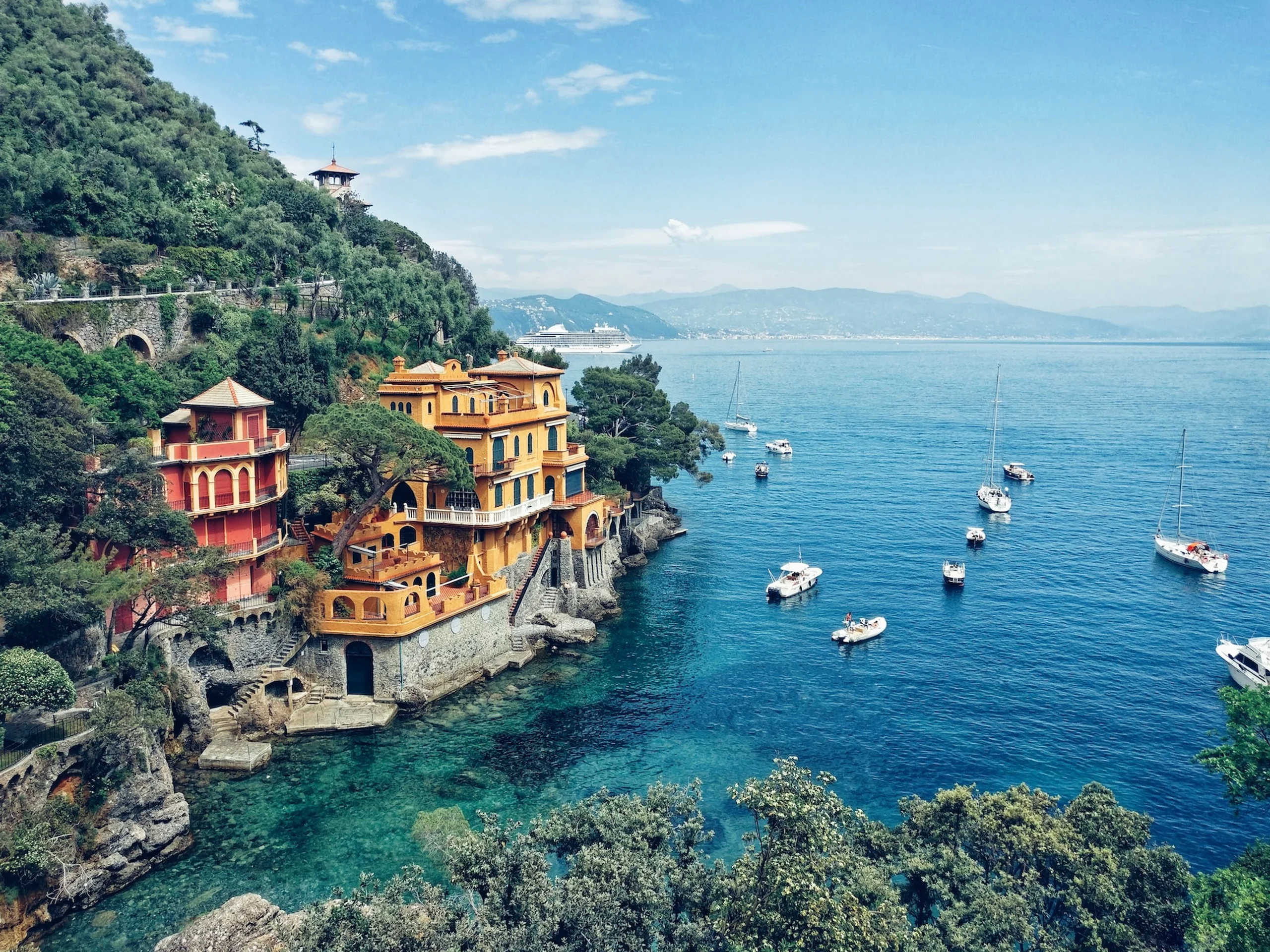 Piccolo Hotel and Portofino coastline overlooking blue ocean and sailing boats 
