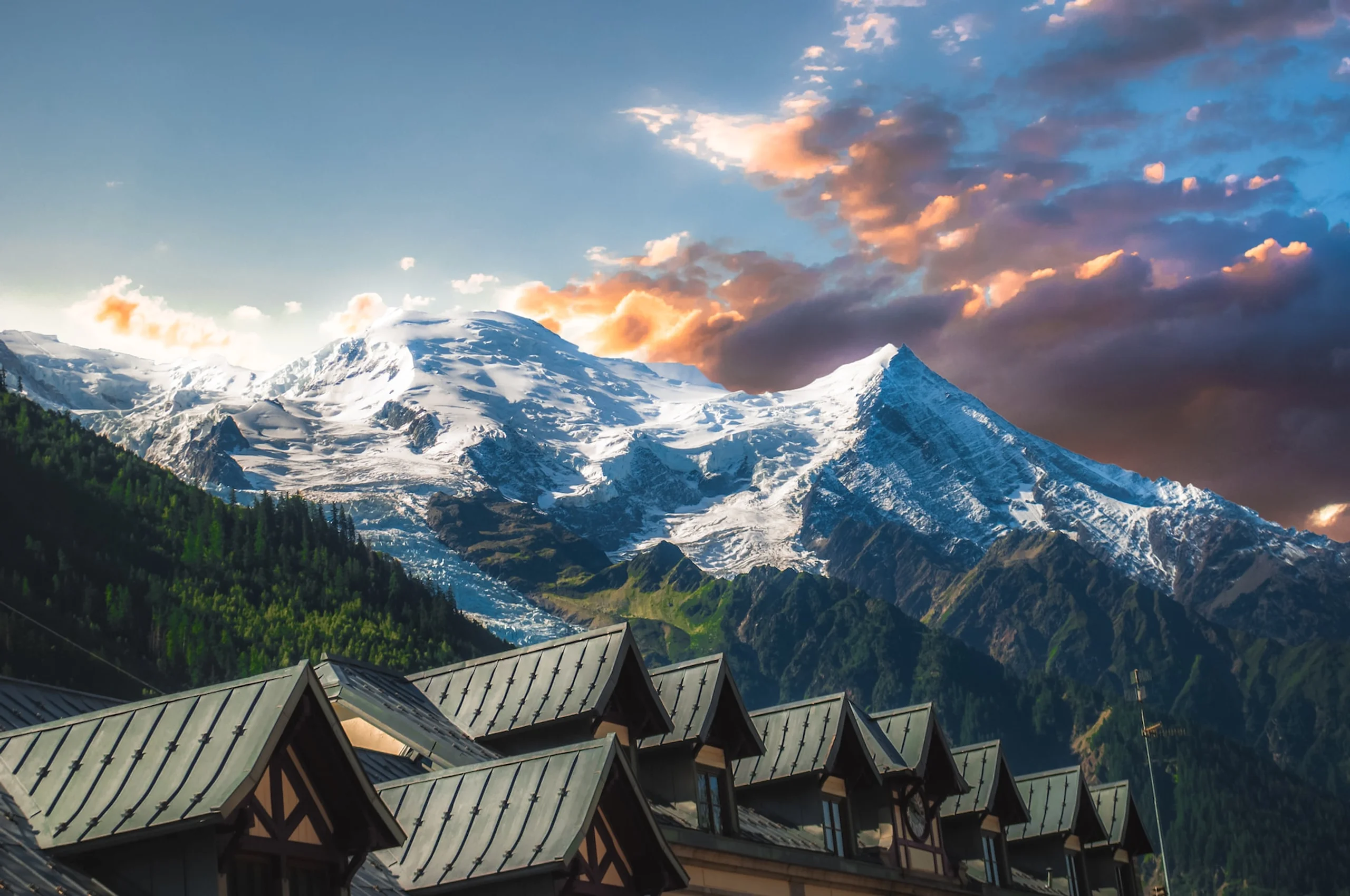 Snow capped Swiss Alps and triangular roofs