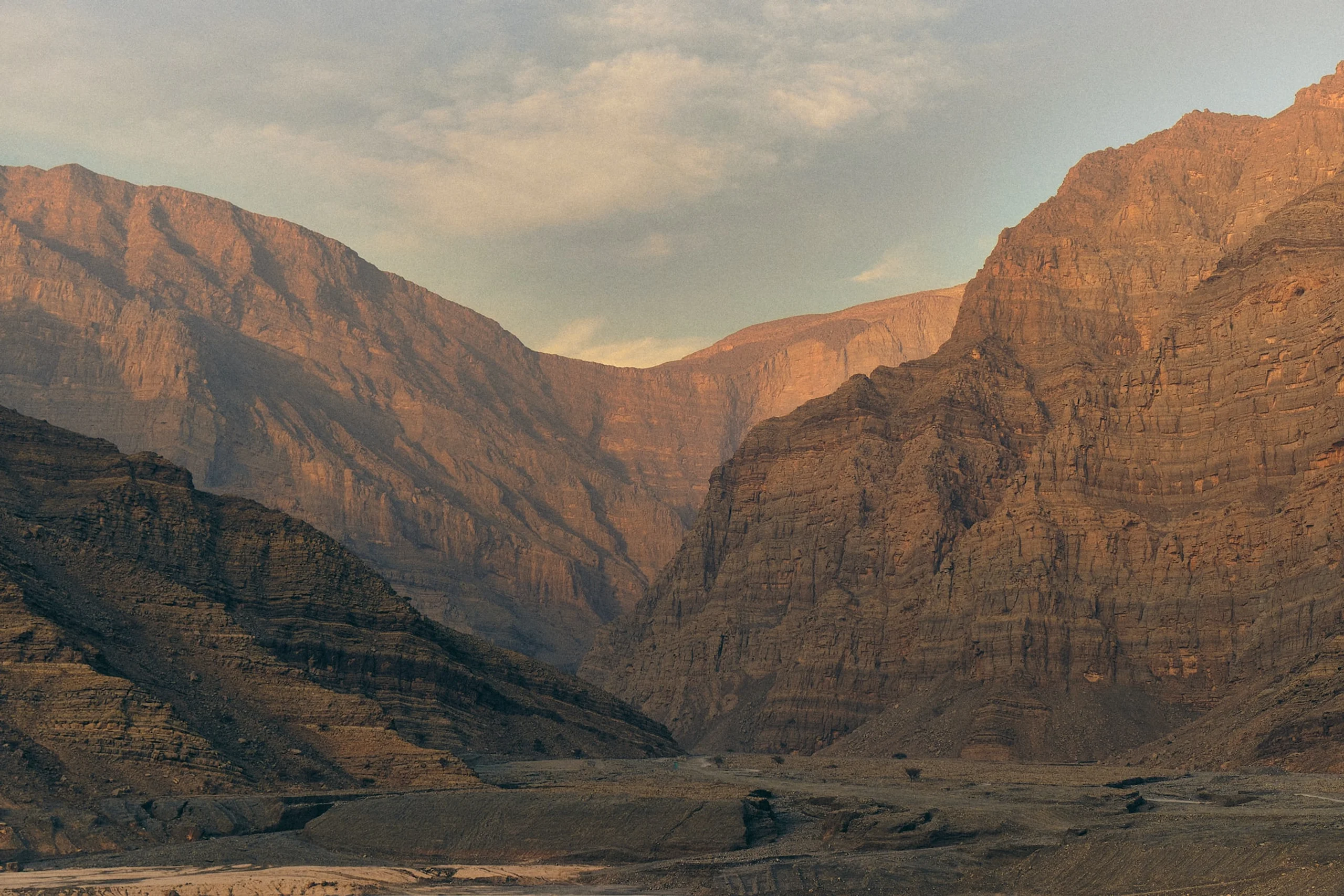 Rocky mountains in Ras Al Kaimah with sunsetting on the rocks and blue sky