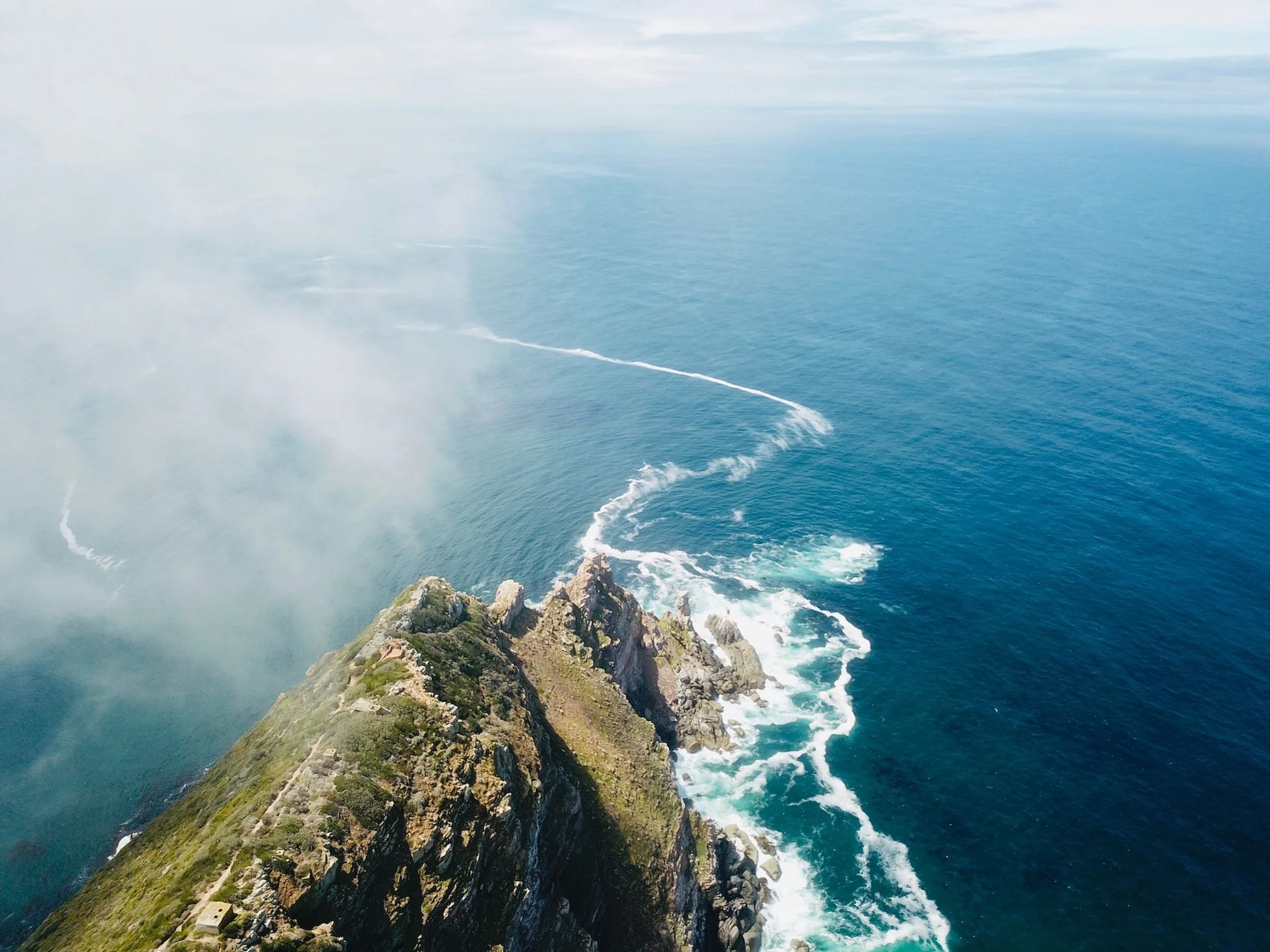Cape Point with mountain edge leading into the blue Atlantic ocean